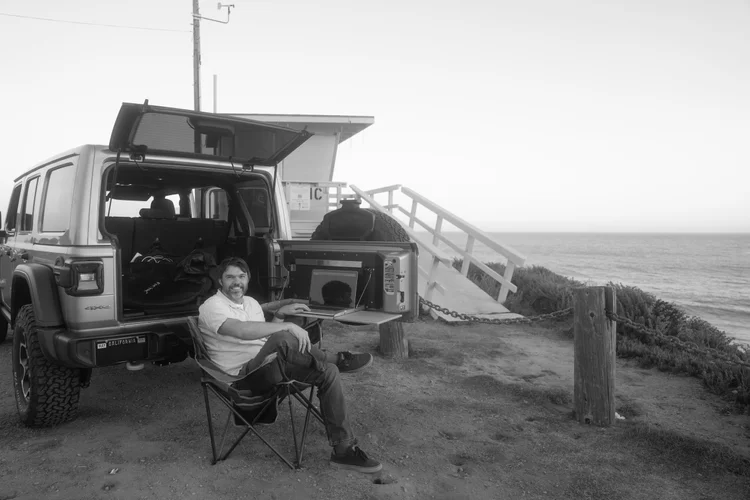 Gabe Thorburn editing on a laptop at the coast